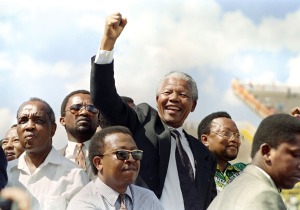 (FILES) -- A file photo taken on March 15, 1994 shows the President of the African National Congress (ANC) Nelson Mandela raising a clenched fist to supporters upon his arrival for an election rally ahead of the April 27 general elections in Mmabatho. South Africans will vote 27 April 1994 in the country's first democratic and multiracial general elections.   AFP PHOTO / WALTER DHLADHLAWALTER DHLADHLA/AFP/Getty Images ORG XMIT:
